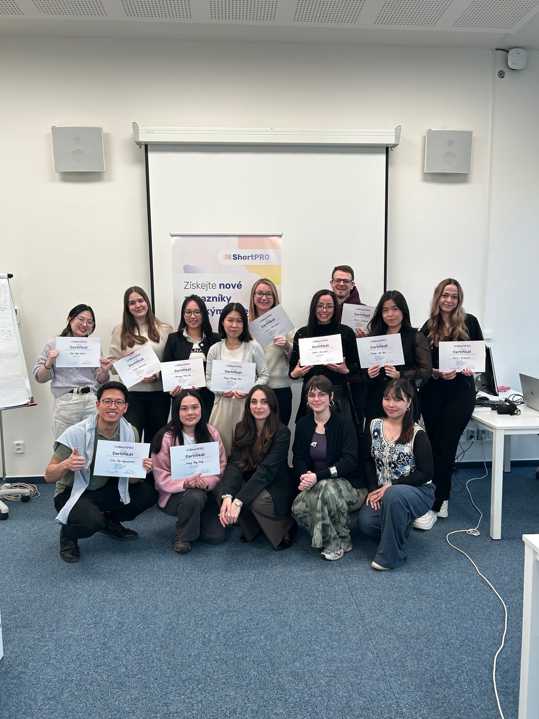 Tereza and workshop participants holding certificates at ShortPRO.